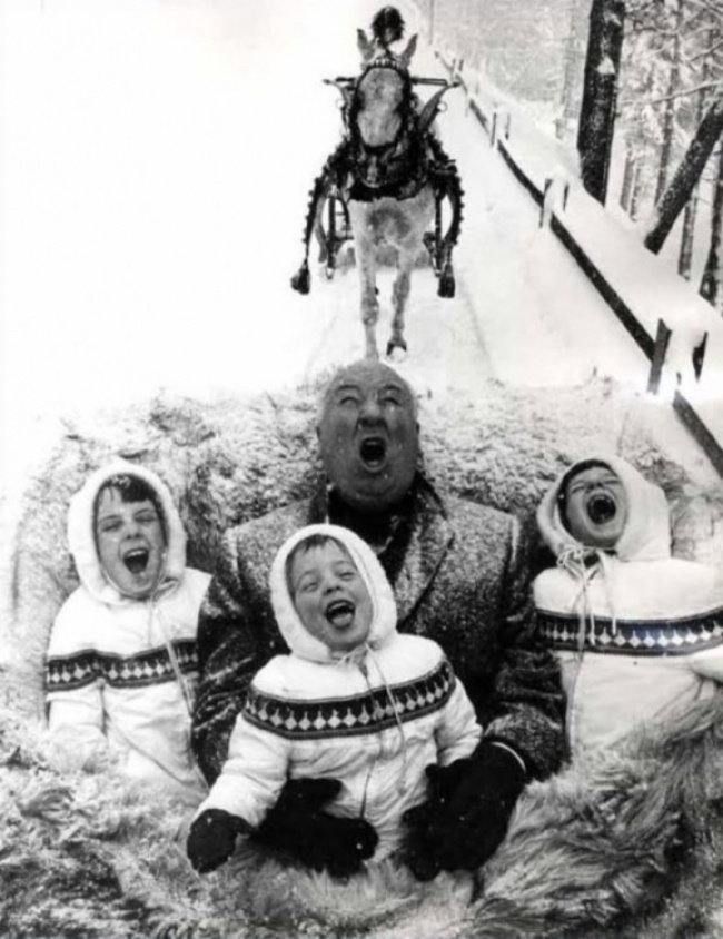 Alfred Hitchcock playing with his grandchildren
