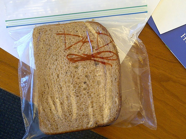 A girl makes her dad sandwiches for him to take to work