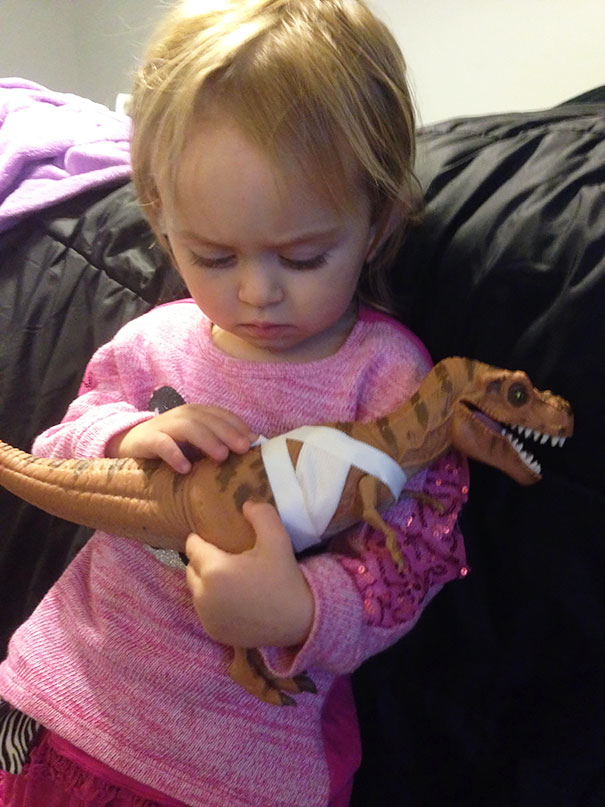 This little girl is taking care of her wounded dinosaur