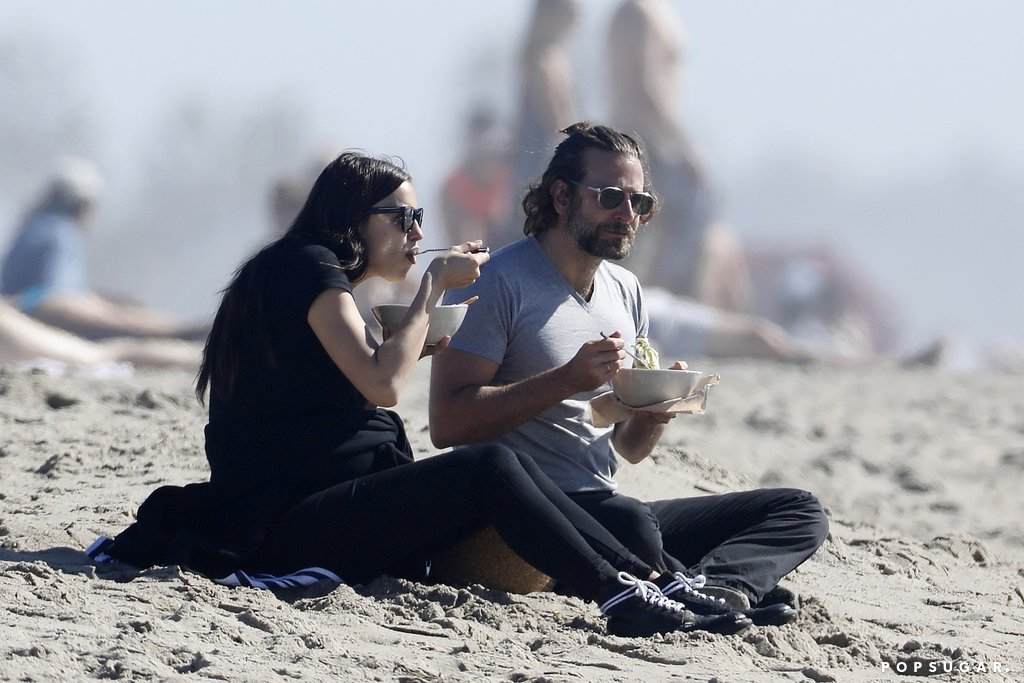 Irina and Bradley Cooper having a picnic on the beach
