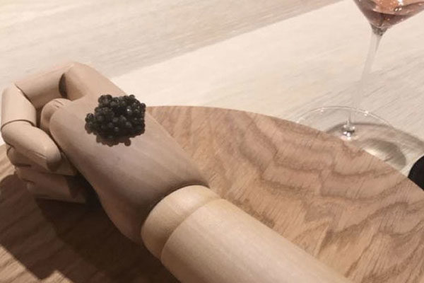 Caviar on a wood hand